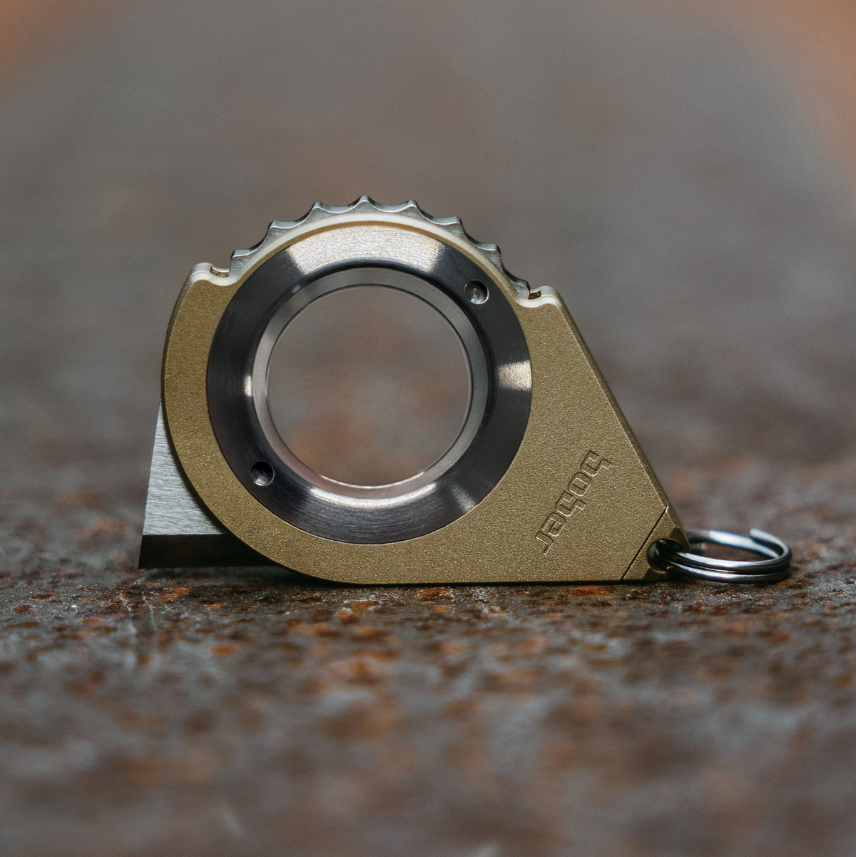 Brass BOBER close-up showing the slim steel ring and wheel